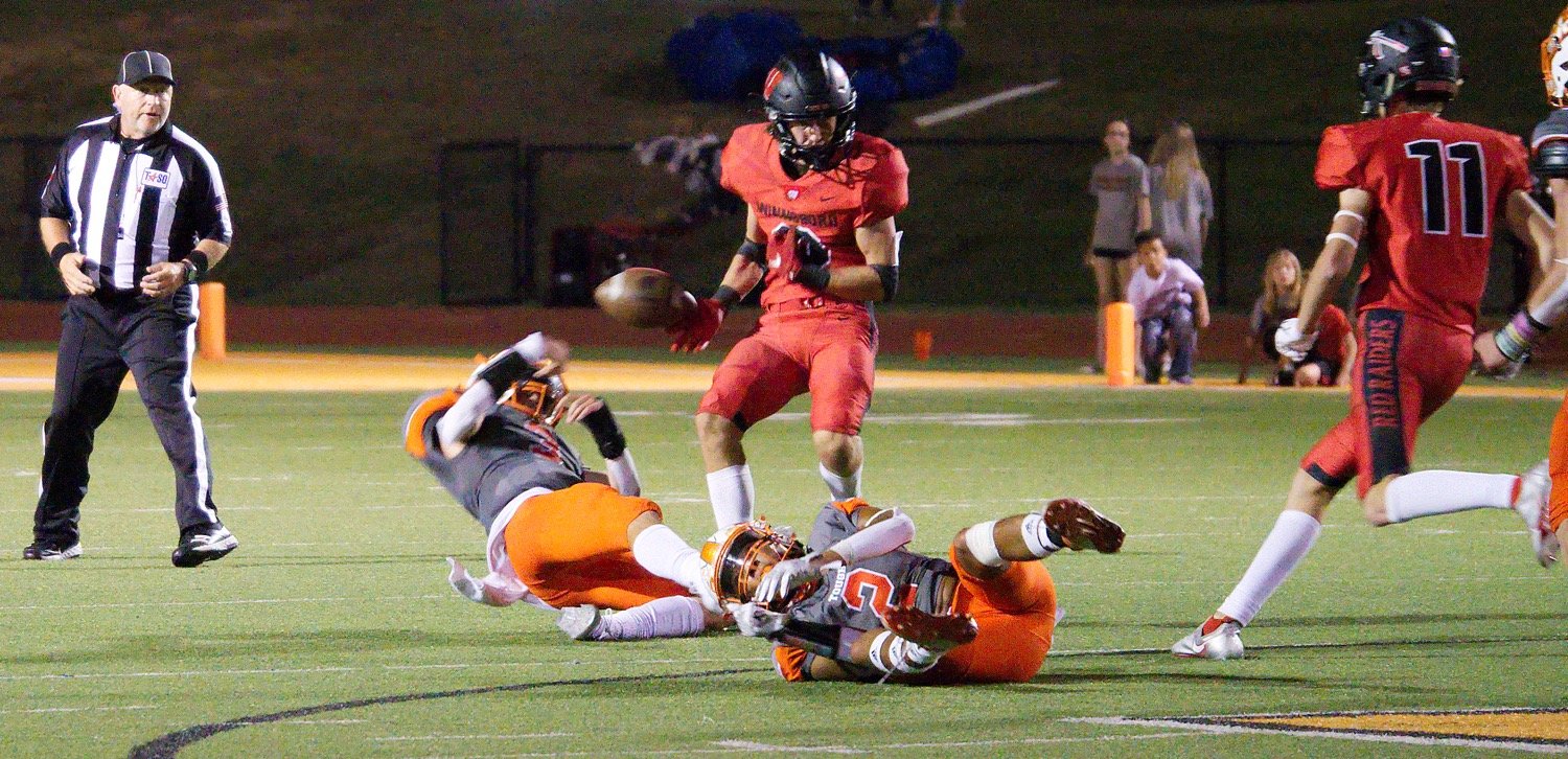 Mineola’s TJ Moreland strips the ball from the Winnsboro receiver, after it had been tipped by a Mineola defender, followed by a Yellowjcket recovery to secure the win.  [more of the cross-county contest]